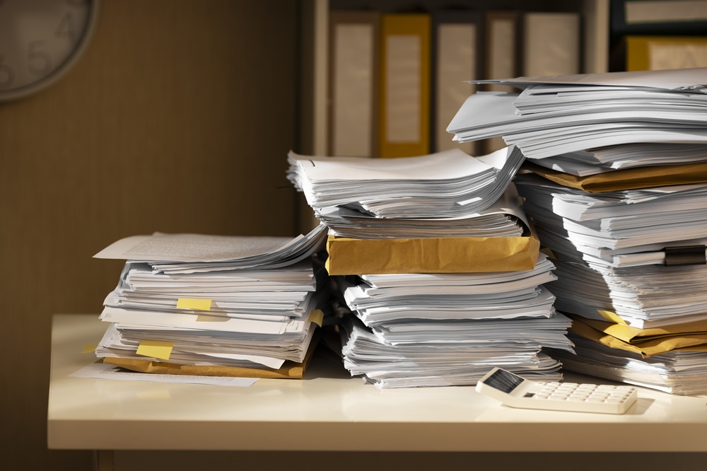 Overloaded office paperwork and document files requiring manual management