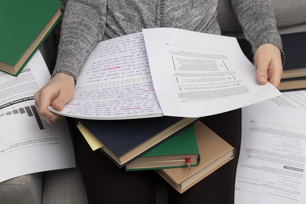 Student information is spread across notebooks, printed documents, and folders